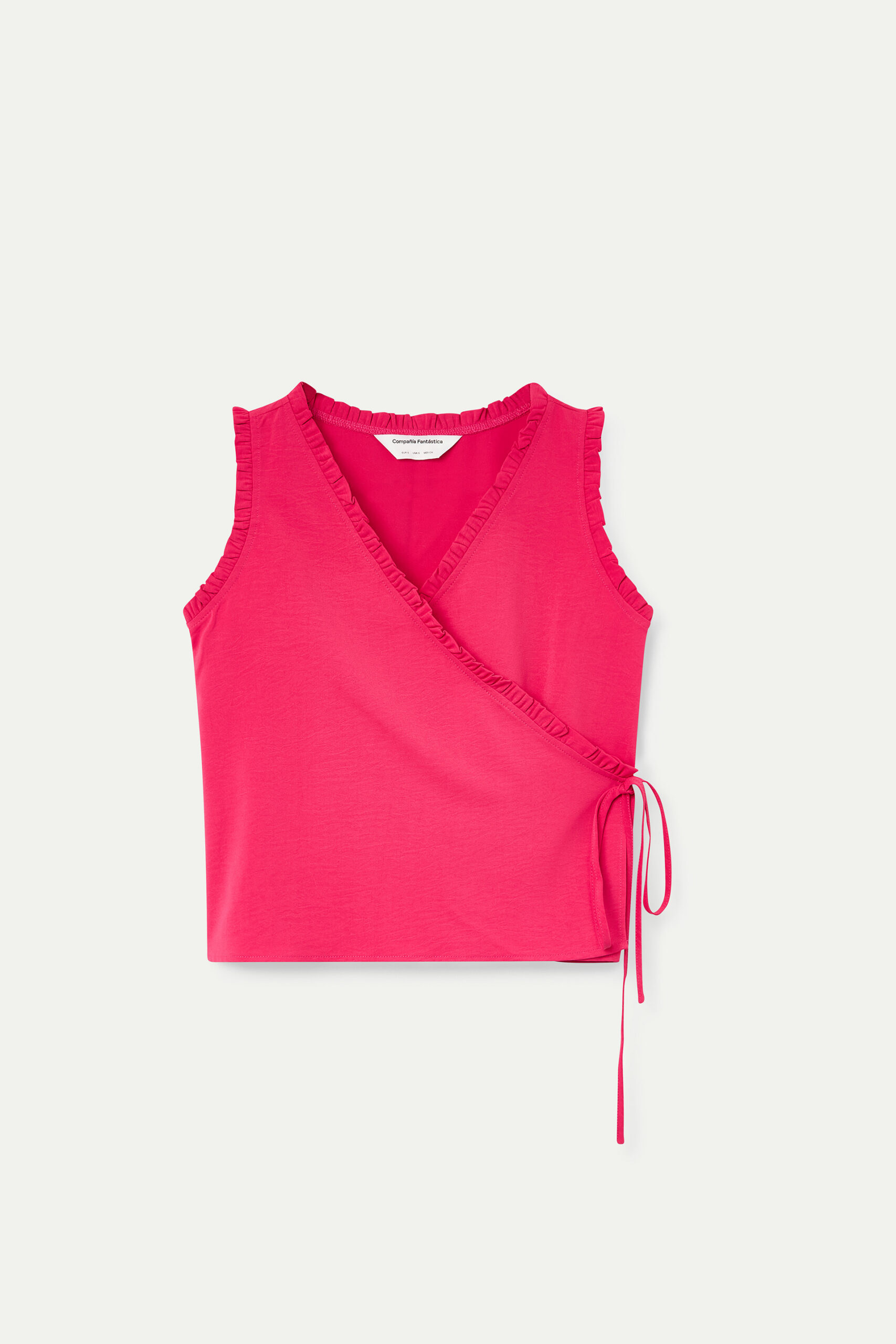 Top fucsia con escote pico y volantes